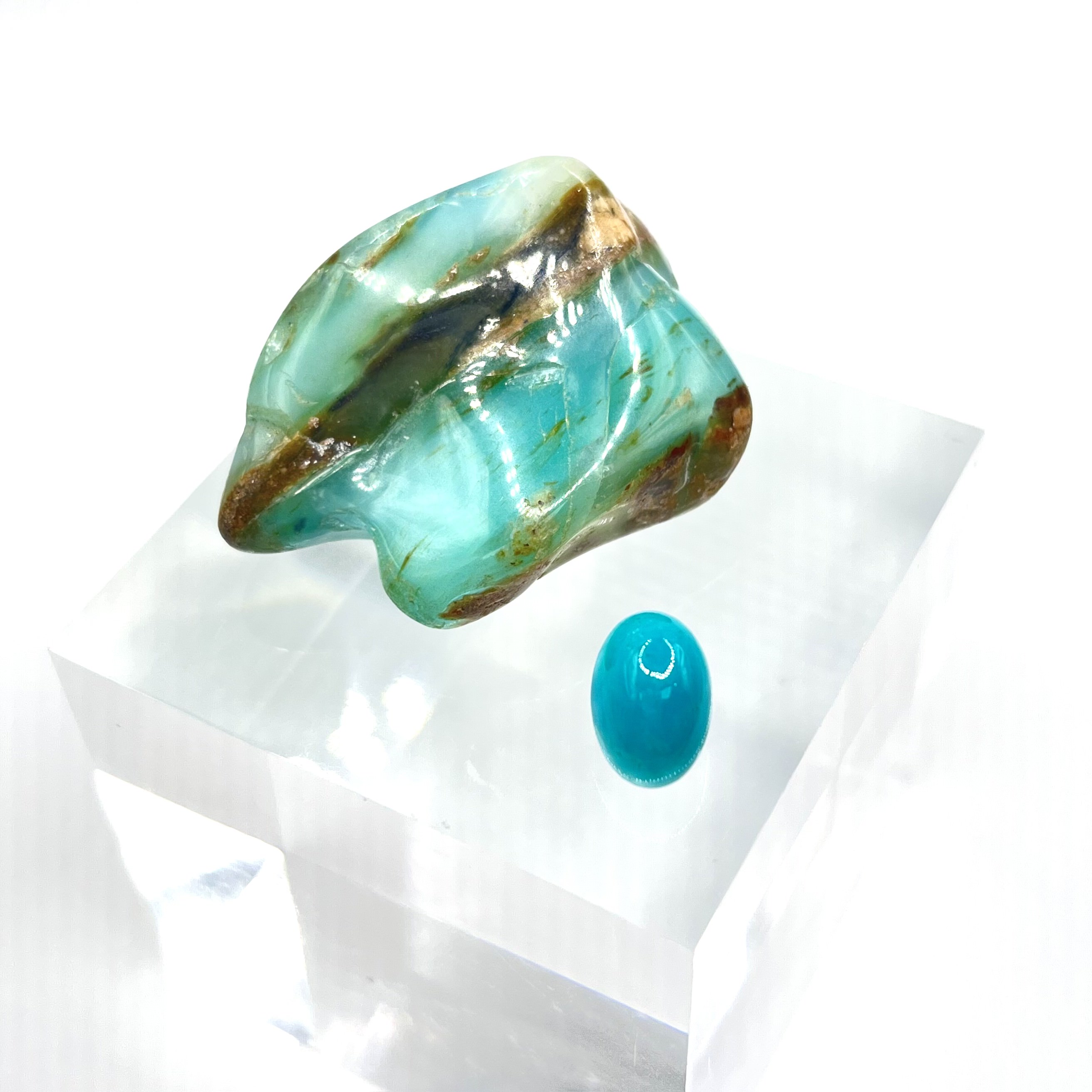 A piece of polished blue opal specimen with a cabochon cut gem quality blue opal.